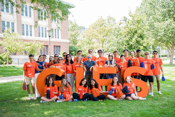 Gies Business Students with Dean Elliott in Front of Large Gies Letters