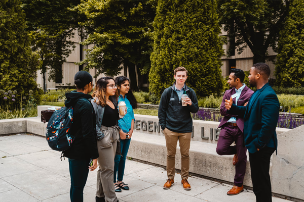 iVenture Students Talking in a Circle Outside with Coffee