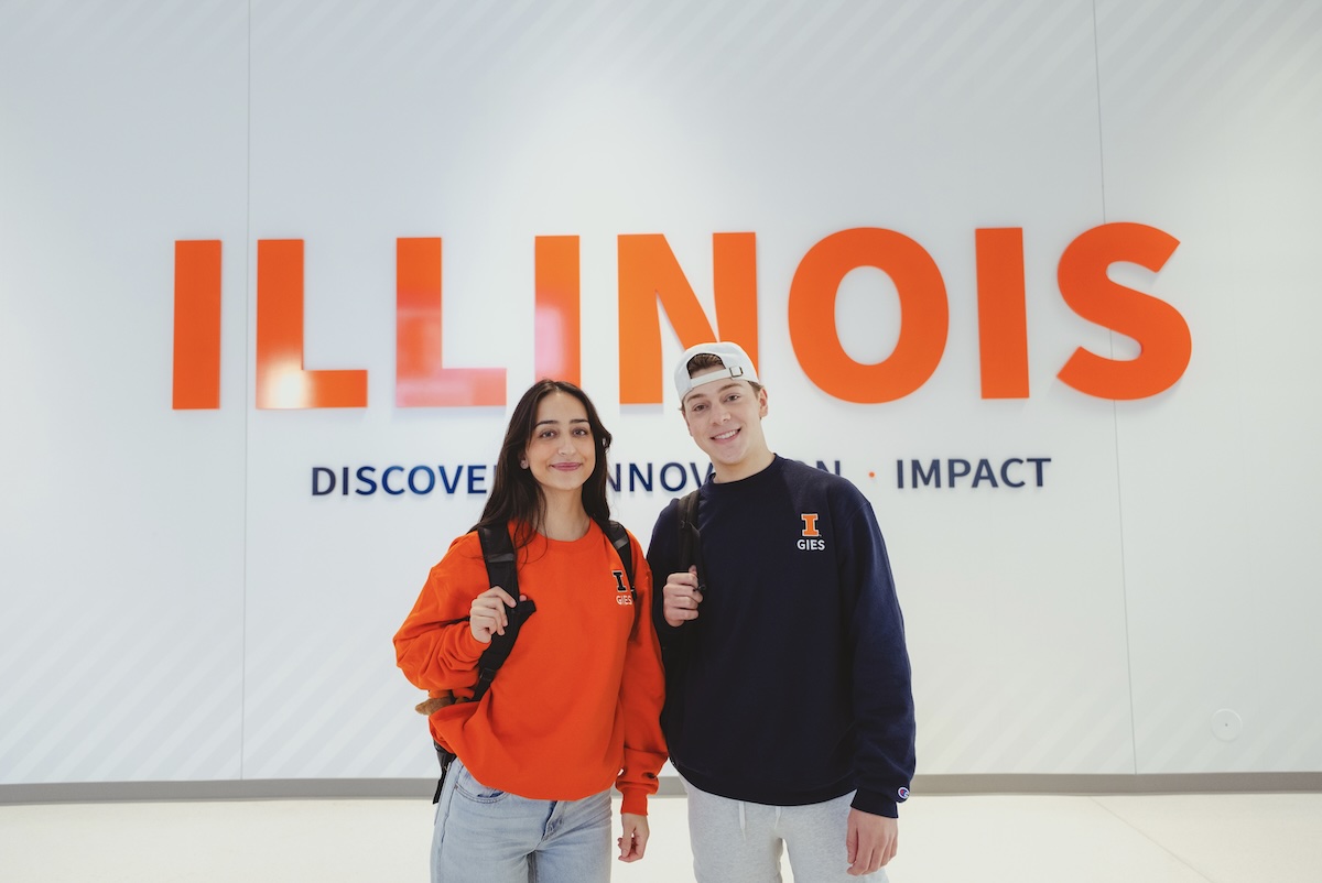Students standing in Wymer Hall smiling