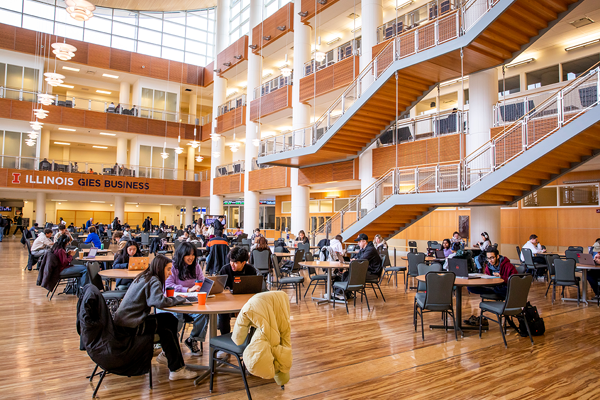 Students Sitting at Tables in the Lincoln International Atrium at Business Instructional Facility