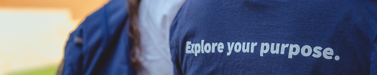 Back of Navy Blue T-Shirt that says Explore Your Purpose