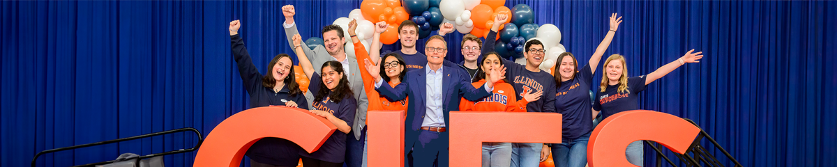 Gies students celebrating at signing day with a balloon background