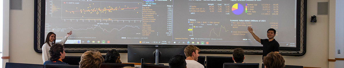 Gies Students Explaining Reports and Graphs to a Classroom of Students