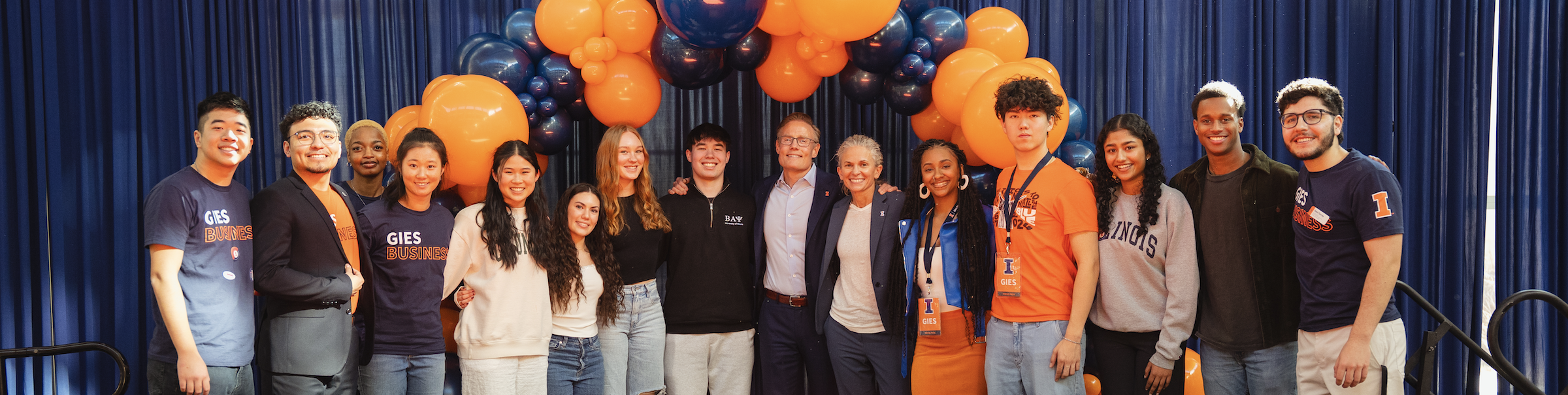 Larry Gies and Brooke Elliott standing with students at Signing Day 2025